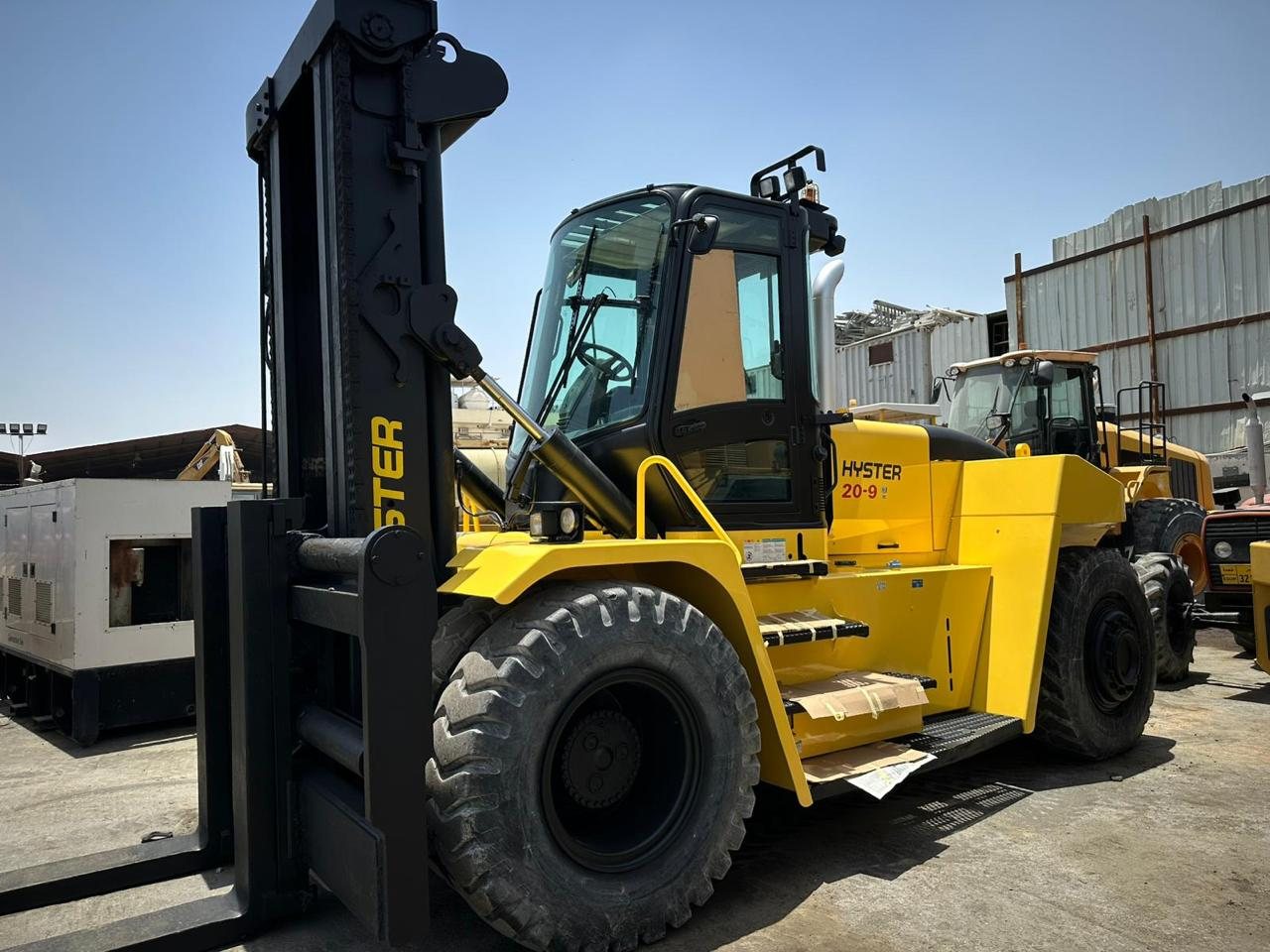 Forklifts in an industrial yard