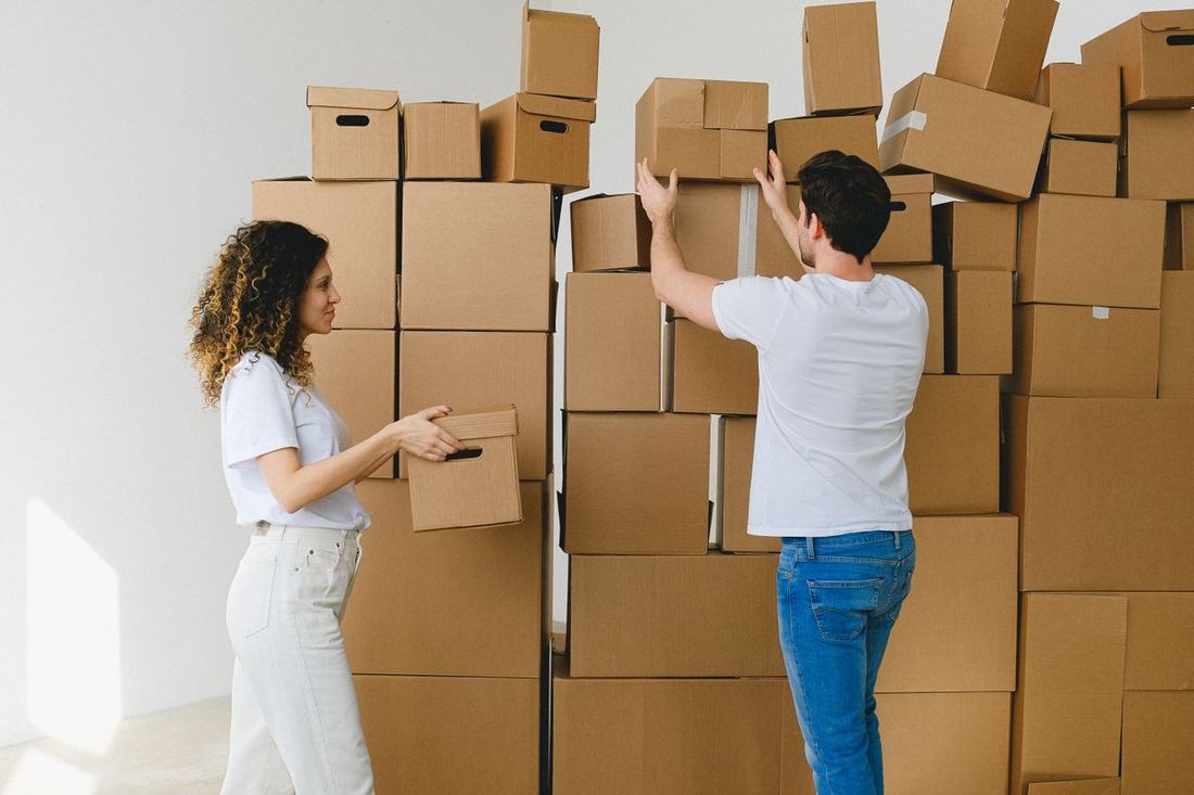 Couple packing moving boxes