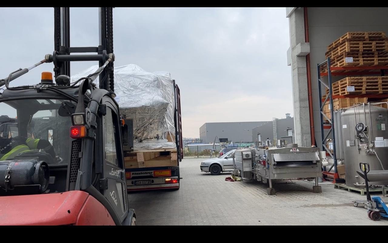 Forklift moving wrapped cargo at a Fateen warehouse facility